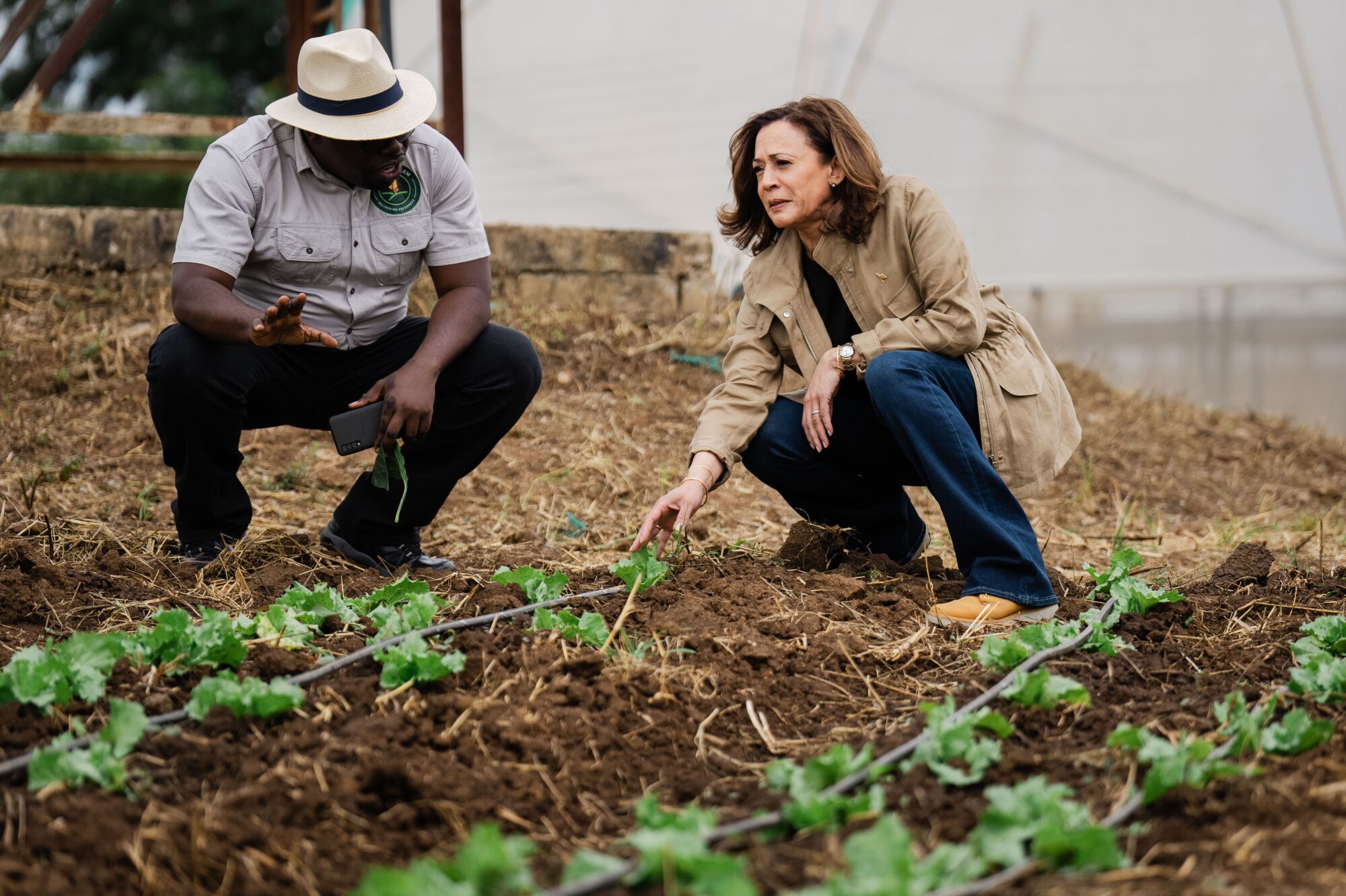 Bruno Mweemba gives U.S. Vice President Kamala Harris a tour of a farm near Lusaka, Zambia.