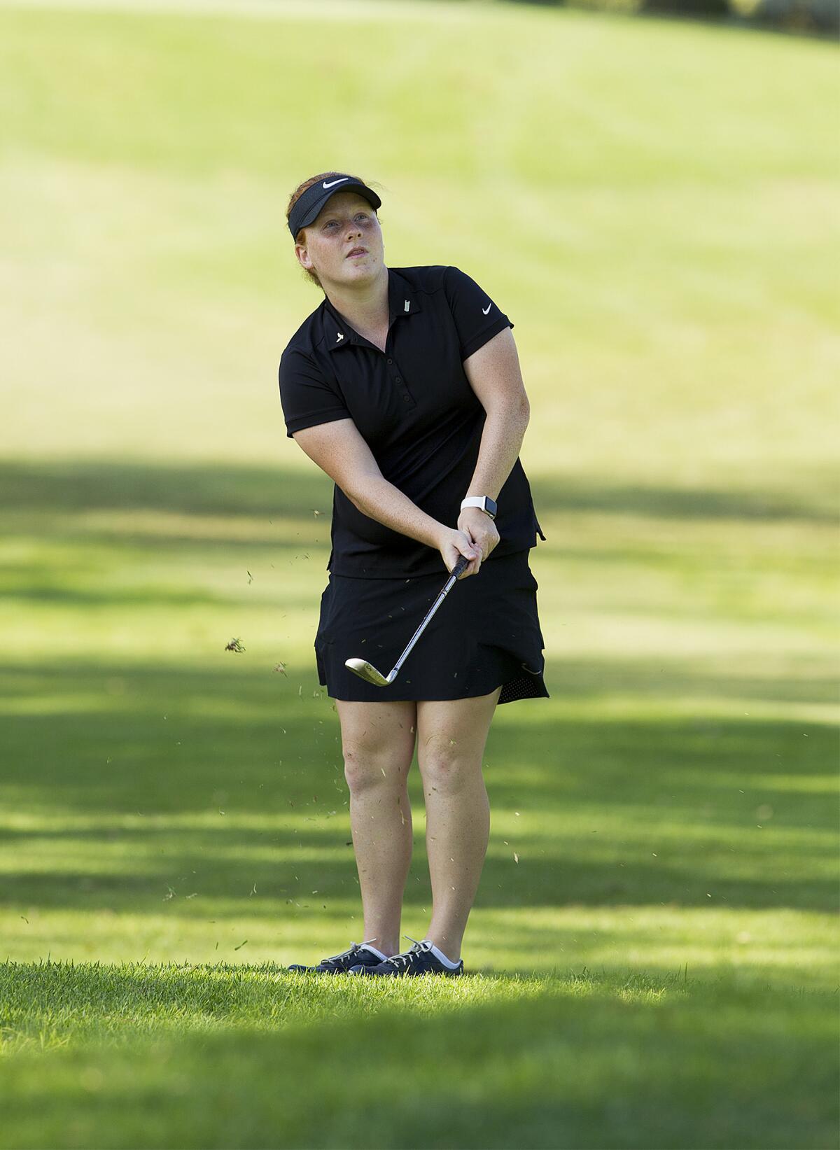 Estancia's Lexi Thorpe chips on to the green during a girls' golf match at Costa Mesa Country Club on Sept. 24, 2018.