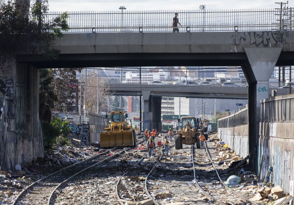 Crews repair a section of detached railroad track near downtown Los Angeles 