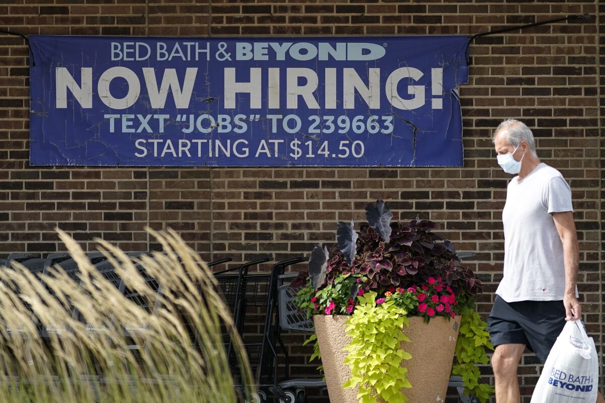 Hiring sign is displayed in Deerfield, Ill., Wednesday, Sept. 21, 2022. The number of Americans filing for jobless benefits dropped last week, a sign that few companies are cutting jobs despite high inflation and a weak economy. Applications for unemployment benefits for the week ending Sept. 24 fell by 16,000 to 193,000, the Labor Department reported Thursday, Sept. 29. (AP Photo/Nam Y. Huh)