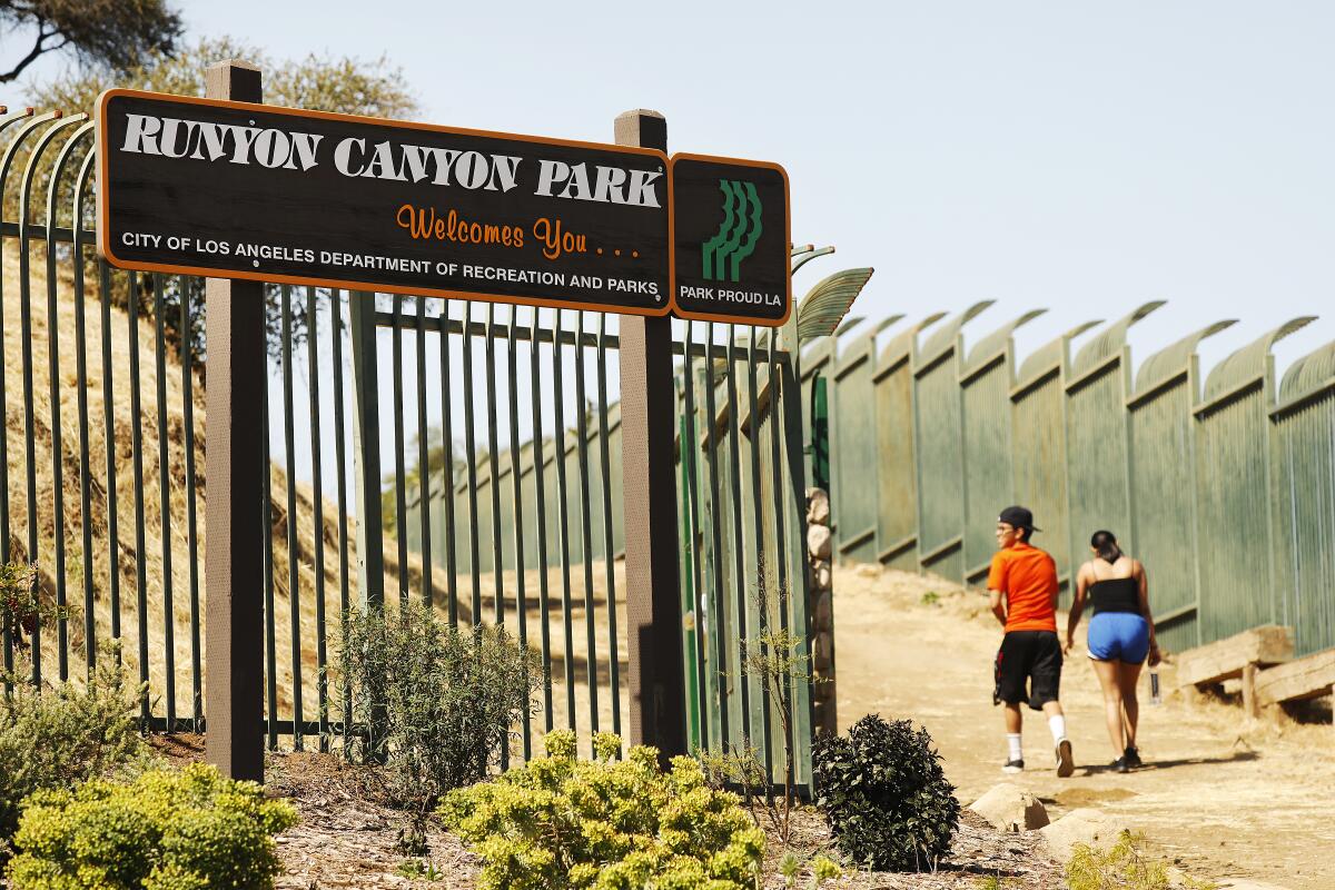 People enter through the north gate of Runyon Canyon Park in the Hollywood Hills