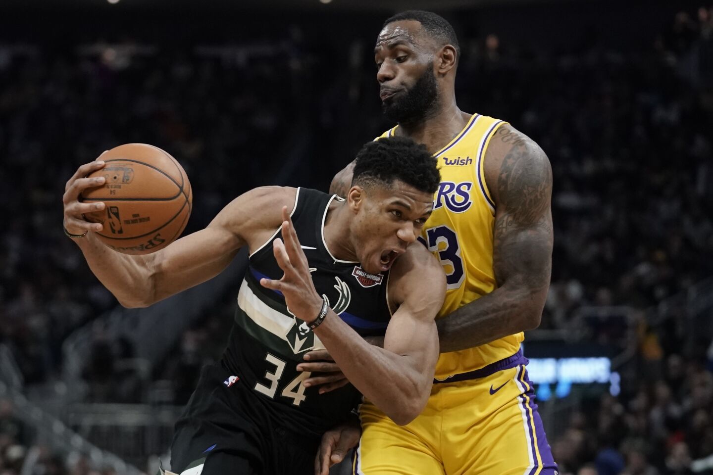 Bucks forward Giannis Antetokounmpo tries to drive past Lakers forward LeBron James during the second half of a game Dec. 19.