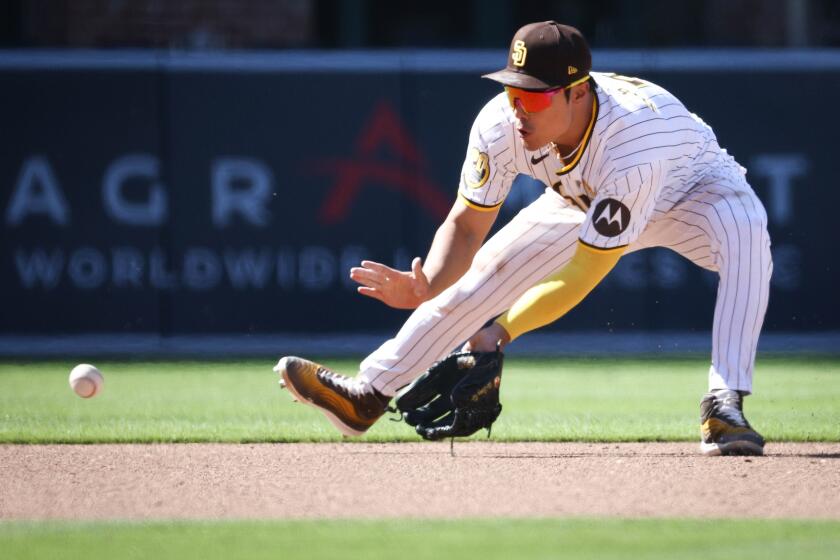 San Diego, CA - April 03: San Diego Padres shortstop Ha-Seong Kim (7) fields a ground ball against the St. Louis Cardinals during the eighth inning at Petco Park on Wednesday, April 3, 2024 in San Diego, CA. (Meg McLaughlin / The San Diego Union-Tribune)