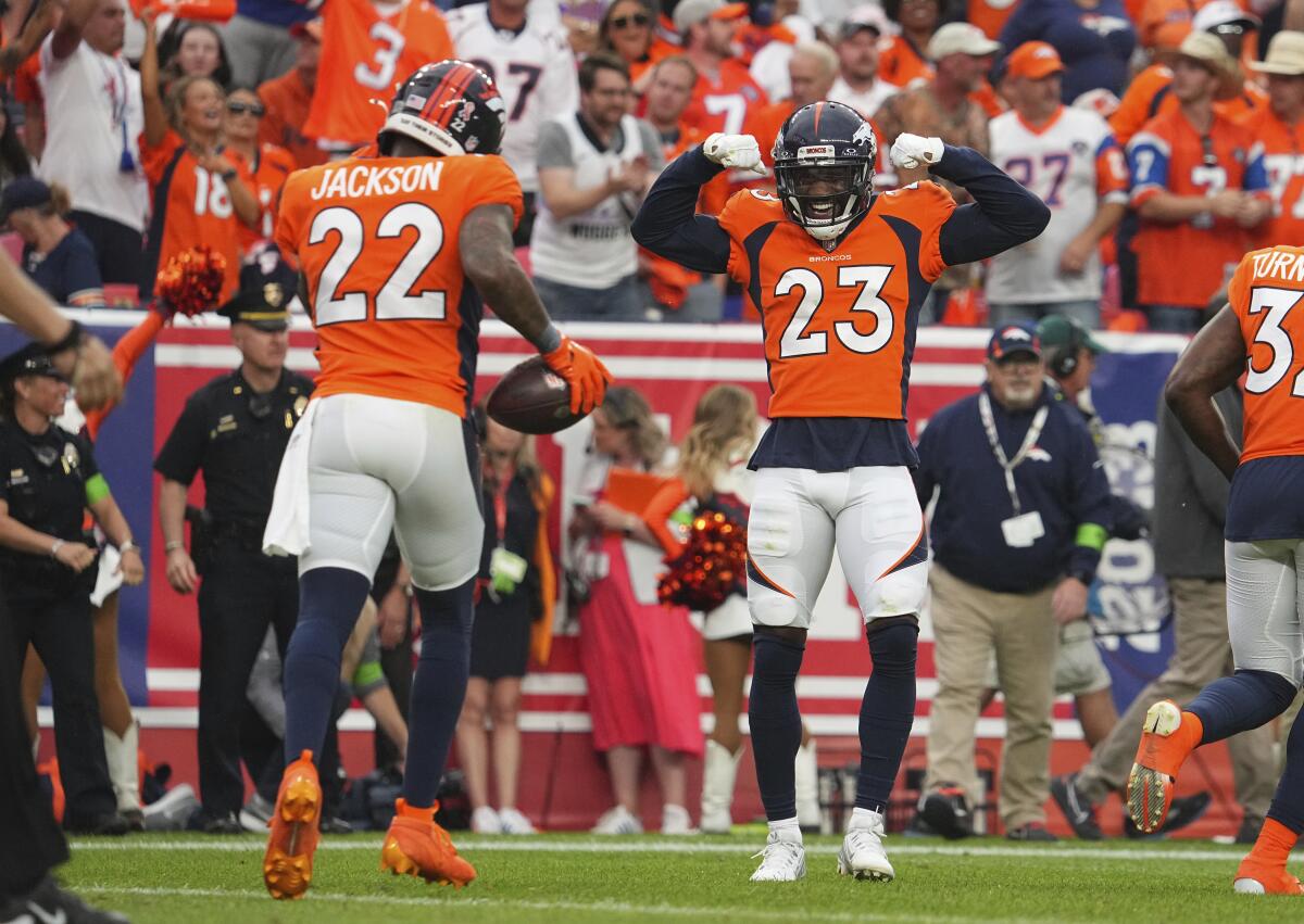 Denver Broncos safety Kareem Jackson and Denver Broncos cornerback Tremon Smith  celebrate a touchdown.