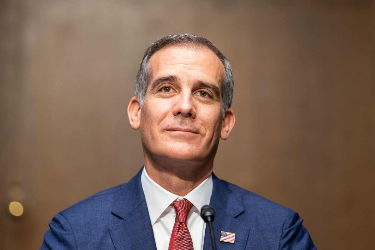 Close up of Los Angeles Mayor Eric Garcetti wearing a blue suit with a red tie