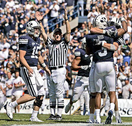 Brigham Young quarterback Max Hall runs toward receiver Michael Reed after throwing a 12-yard touchdown pass to him in the second quarter Saturday.