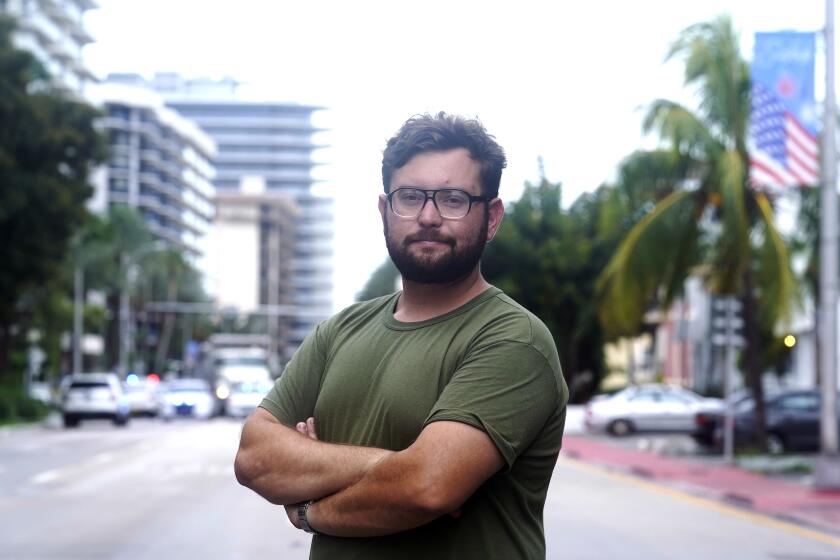 Ryan Mermer stands near his apartment in the historic section of Surfside, Fla., Tuesday, June 29, 2021. Mermer moved back from Palm Beach County to be near his parents and to be part of an active Jewish community. (AP Photo/Marta Lavandier)