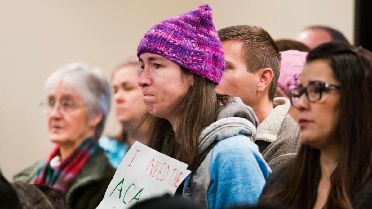 A woman at a town hall meeting held by Rep. Ami Bera laments the possible loss of her family's ACA coverage in Elk Grove, Calif. (Autumn Payne / Associated Press)