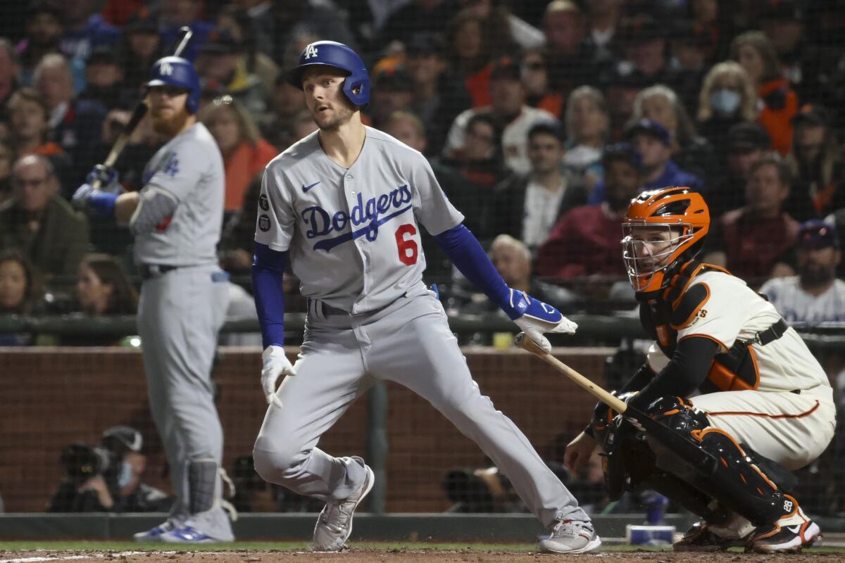 Dodgers batter Trea Turner follows through for a double in the sixth inning.