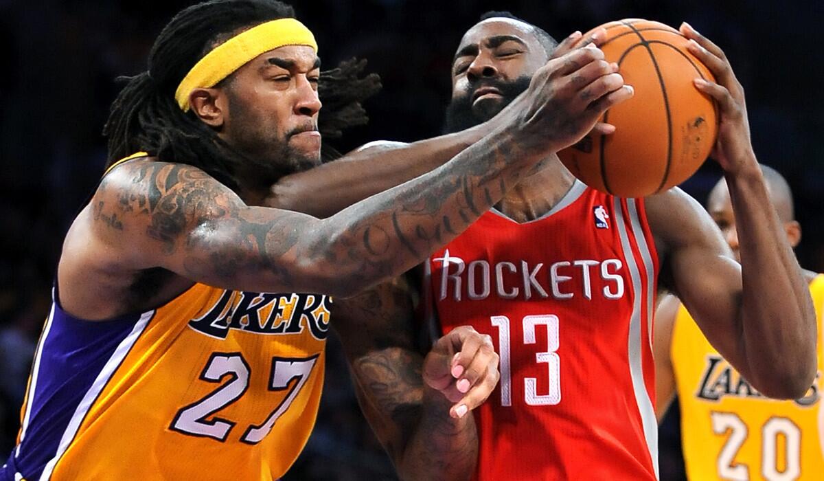 Lakers center Jordan Hill tries to cut off a drive by Rockets guard James Harden during a game last season at Staples Center.