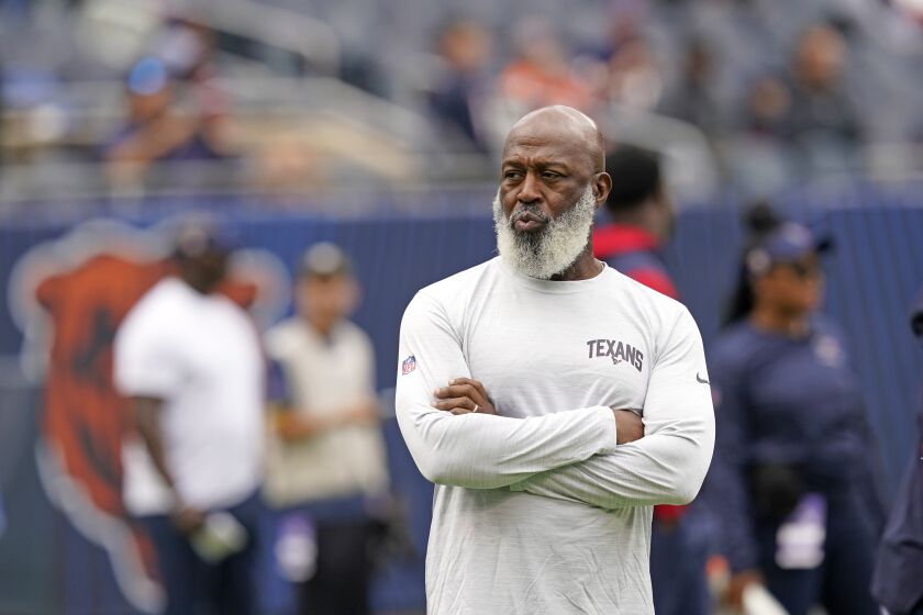 Houston Texans coach Lovie Smith watches players warm up before an NFL football game against the Chicago Bears Sunday, Sept. 25, 2022, in Chicago. (AP Photo/Charles Rex Arbogast)