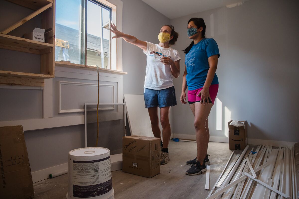 Ruth Haller (left) and Pamela Macias of Girls With Power Tools discuss their latest remodel project in Barrio Logan.