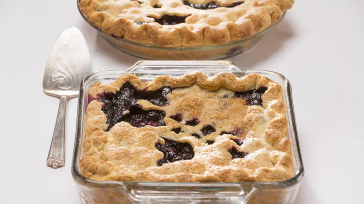 Blueberry pie baked in a square dish.