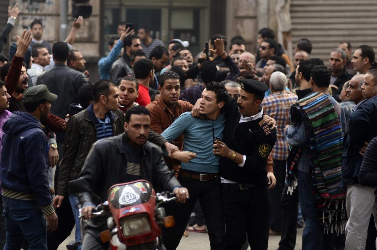 A supporter of ousted Egyptian president Mohamed Morsi is detained by police during clashes with security forces.