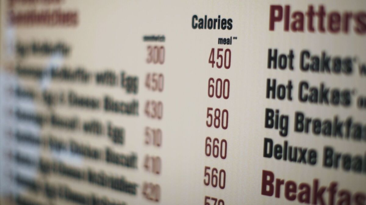 Calories of each food item appear on a McDonalds drive-thru menu in New York.