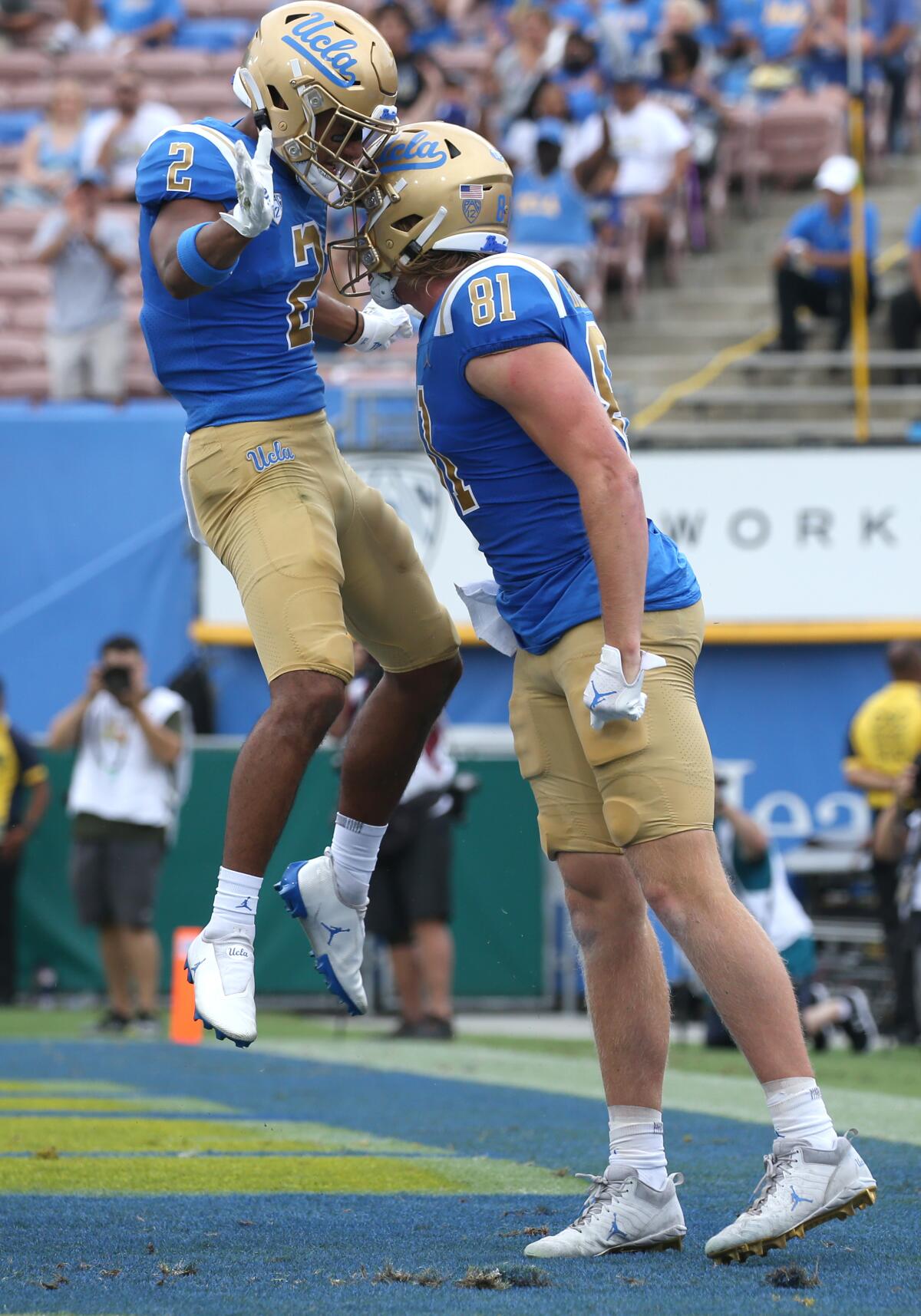 UCLA tight end Hudson Habermehl, right, and wide receiver Titus Mokiao-Atimalala celebrate Habermehl's touchdown grab.