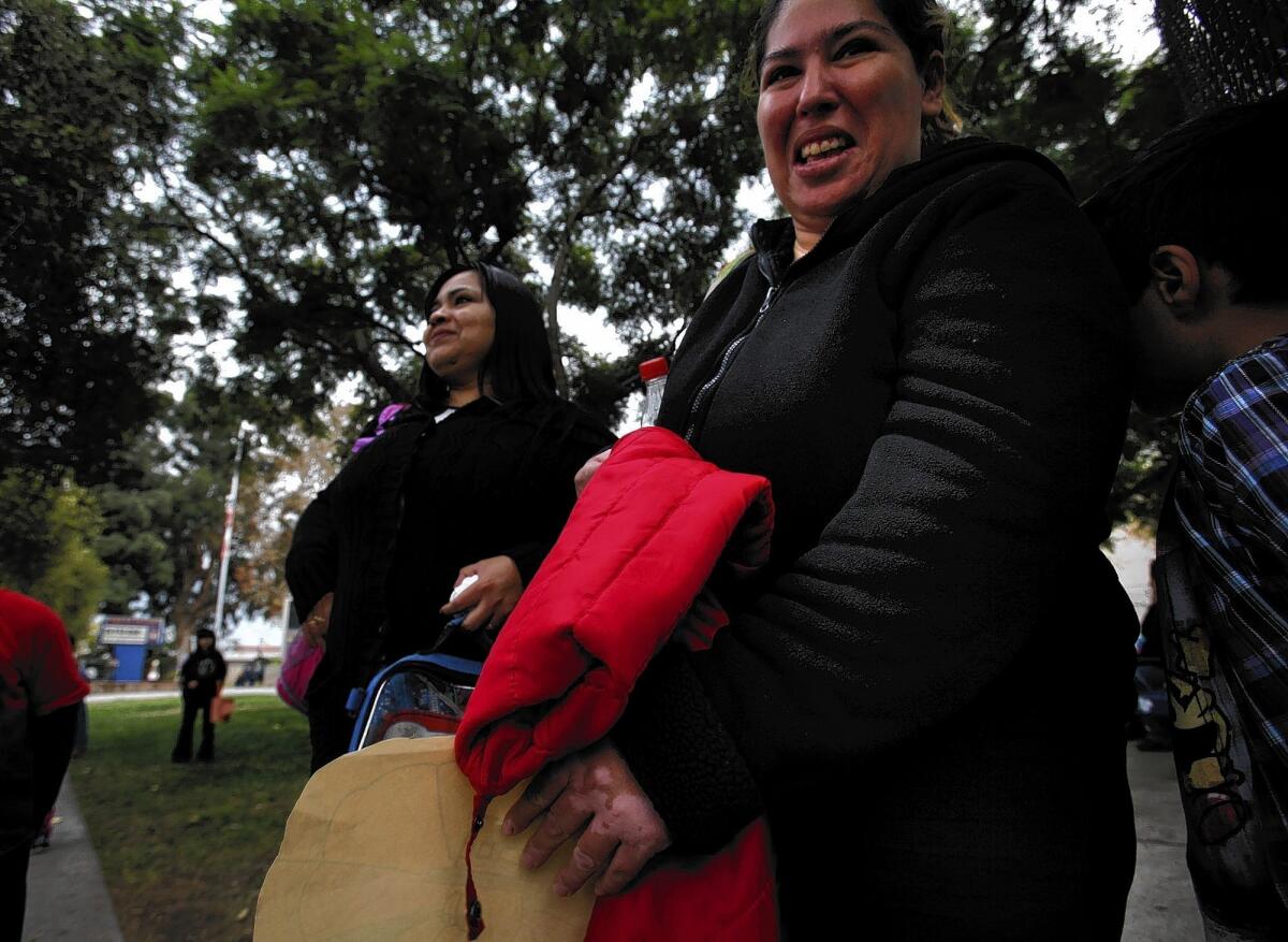 Adelina Garcia, left, and Adriana Serrano walk their children home from Teresa Hughes Elementary School in Cudahy. They were parent leaders in a petition drive last fall to oust the school principal.