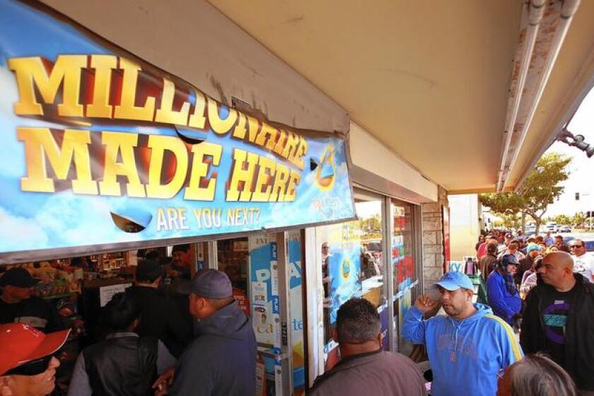 A crowd lines up to buy Powerball lottery tickets at Bluebird Liquor in Hawthorne recently.
