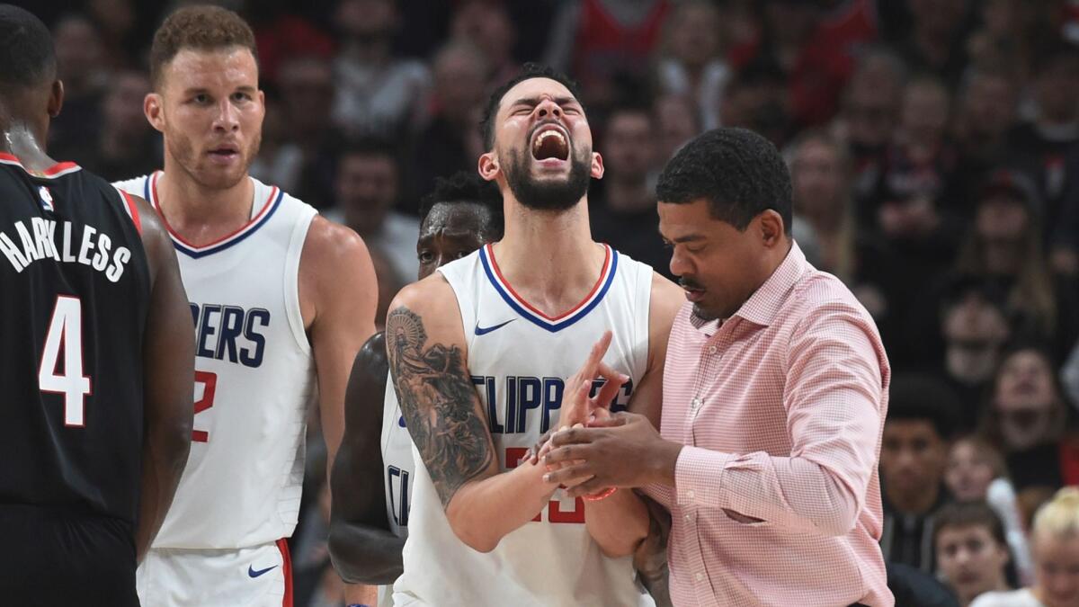 Clippers guard Austin Rivers reacts after injuring his hand against the Portland Trail Blazers on Oct. 26.