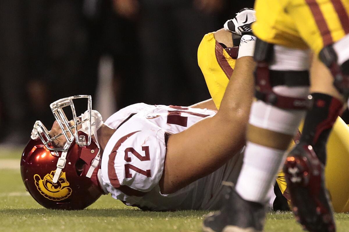 USC offensive tackle Chad Wheeler grabs his right leg during the Trojans' game against Utah on Saturday. Wheeler injured his knee on the third play, but did not leave the game until after seven or eight more plays.