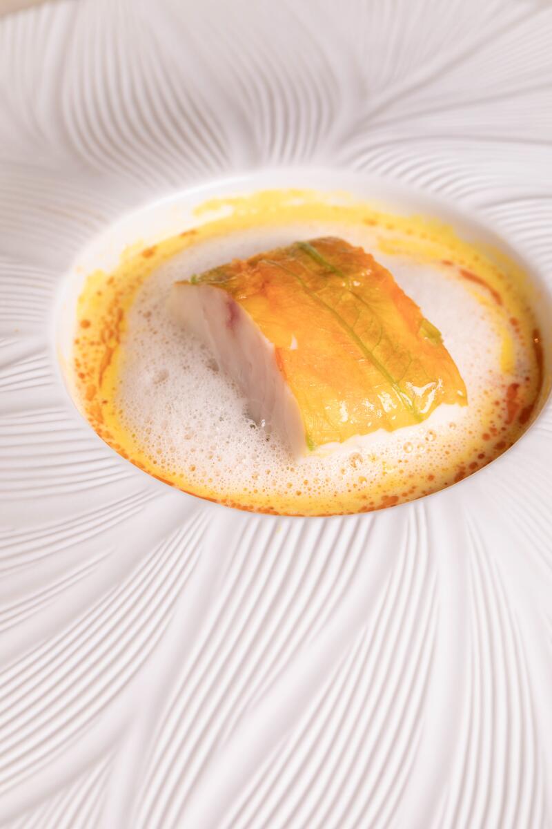 A dish of turbot that looks like the yellow center of a white flower