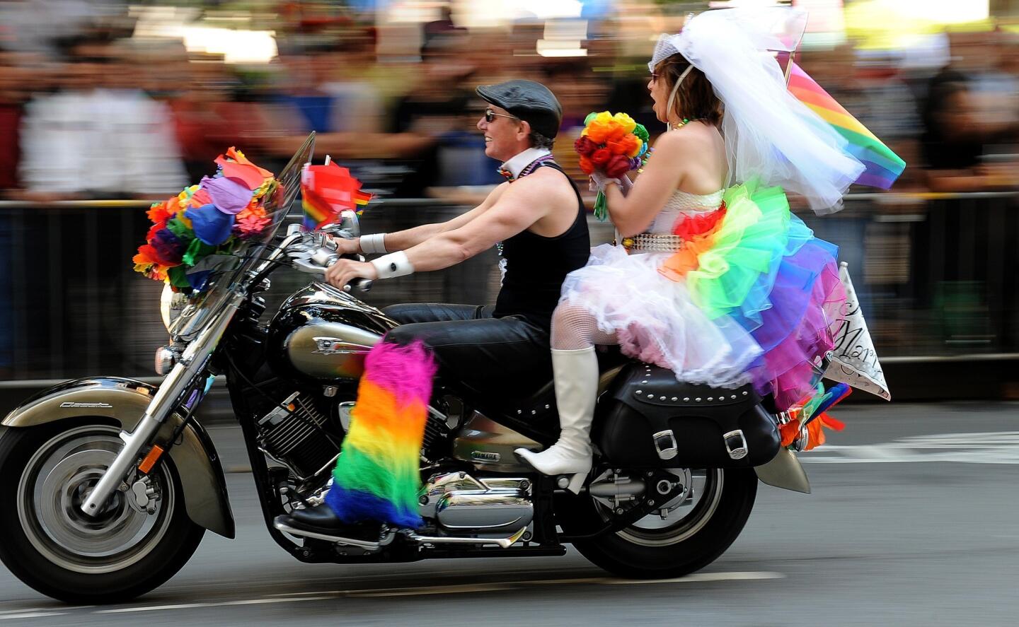 A couple rides down Market Street with a just married sign attached to the motorcycle. In light of the Supreme Court rulings, marriage themes were a big part of the parade.
