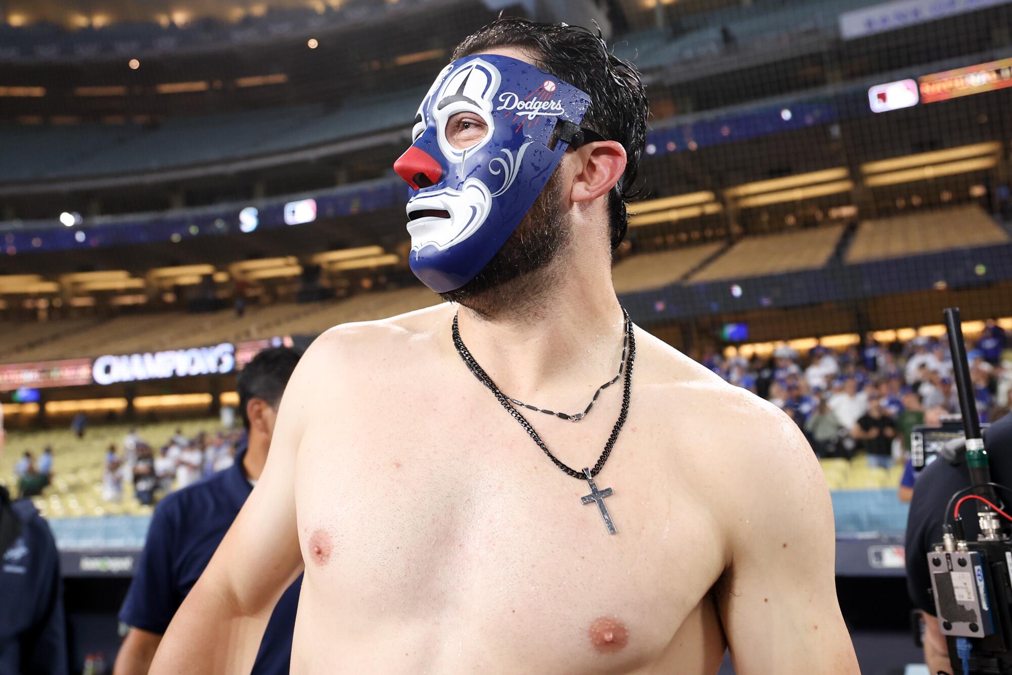 A shirtless Alex Vesia wears a Mister Cartoon clown mask.