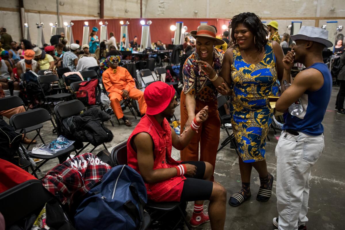 People wait in a room with folding chairs