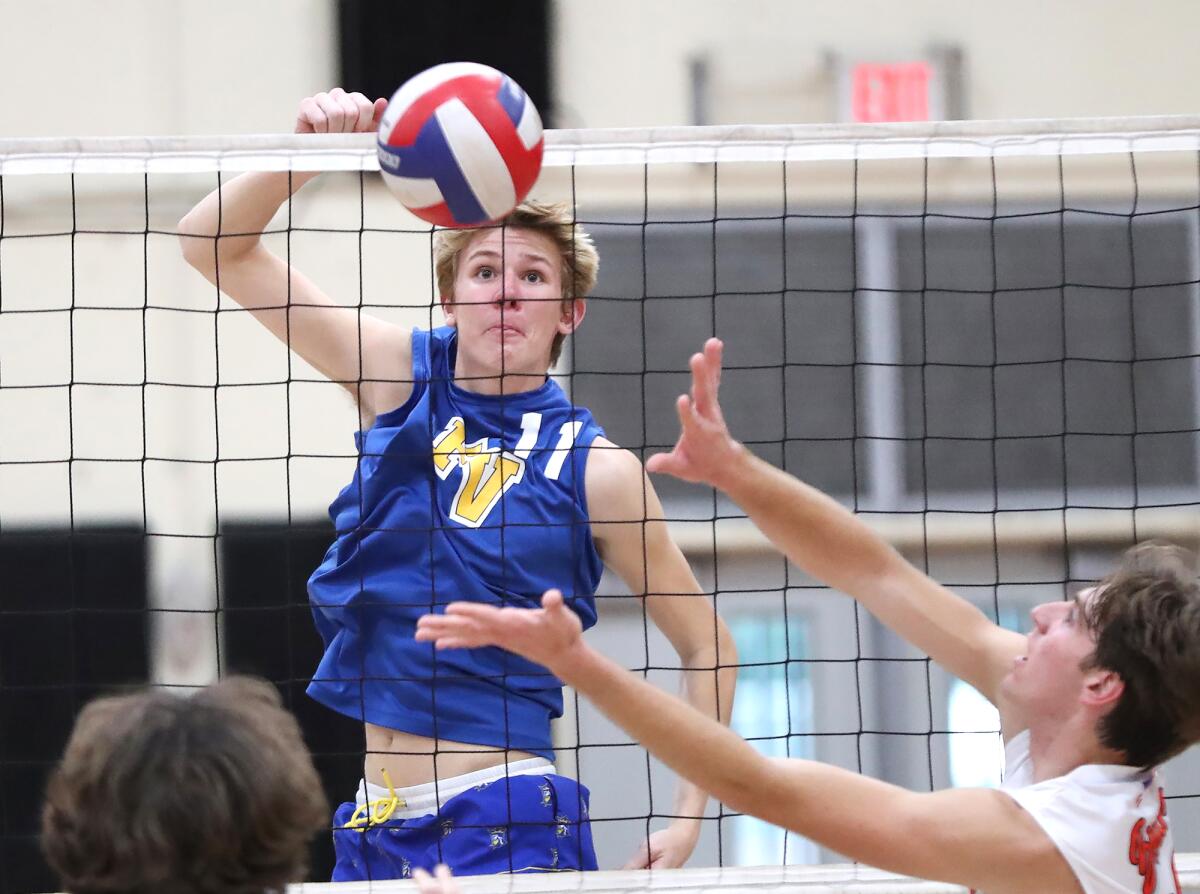 Fountain Valley's Billy Watkins (11) tips a quick-set assist against Huntington Beach on Monday.