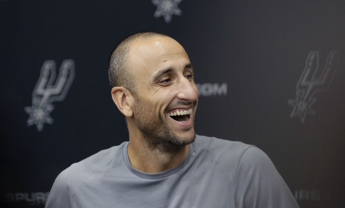 FILE - Former San Antonio Spurs guard Manu Ginobili jokes with the media at the NBA basketball team's practice facility, Saturday, Sept. 15, 2018, in San Antonio. NBA stars Manu Ginobili and Tim Hardaway are among five new Basketball Hall of Fame inductees. Also selected this year were WNBA great Swin Cash, former NBA coach George Karl and long-time college coach Bob Huggins. They will be enshrined into the Naismith Memorial Basketball Hall of Fame in Springfield, Massachusetts, on Sept. 10, 2022 (AP Photo/Eric Gay, File)