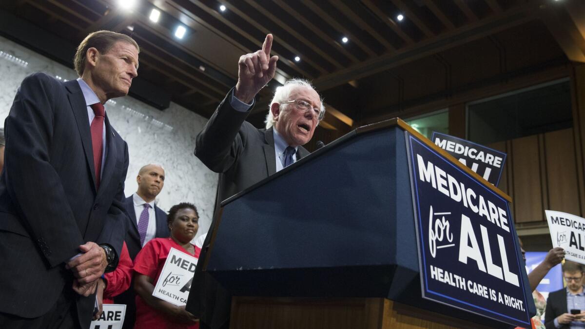 Vermont Sen. Bernie Sanders, center, speaks beside Connecticut Sen. Richard Blumenthal an event announcing Medicare for all in Washington, D.C., on Wednesday.