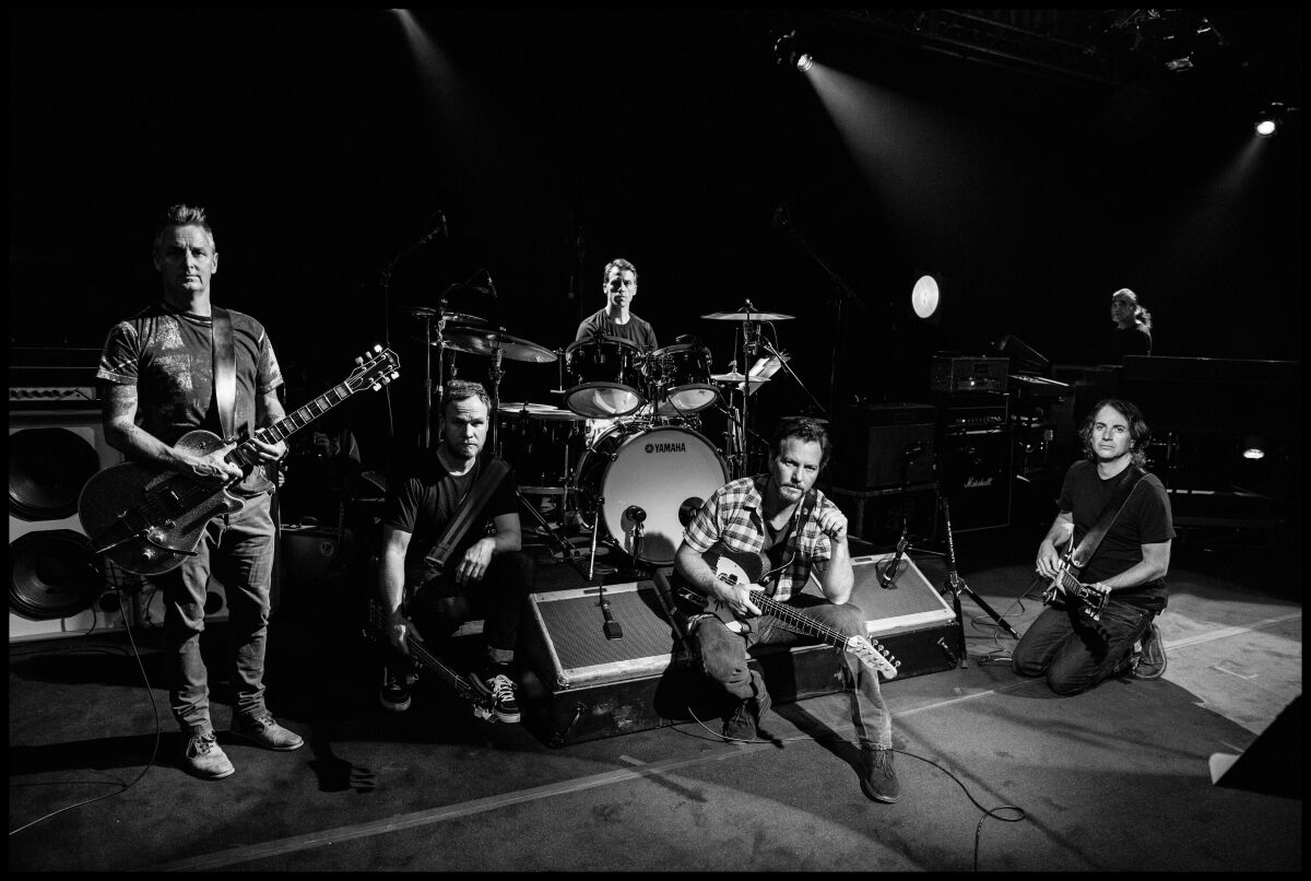 Pearl Jam's lead singer Eddie Vedder, shown crouching at center, is the co-founder of the Ohana Festival in Dana Point.
