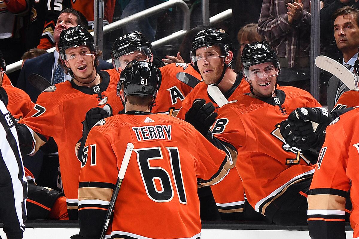 Ducks forward Troy Terry celebrates with teammates after scoring a goal.