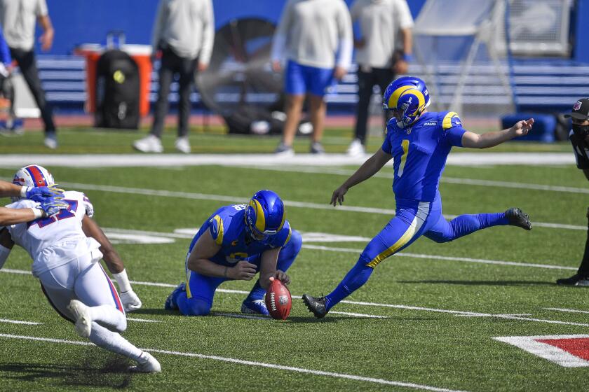 Los Angeles Rams kicker Samuel Sloman, right, winds up for a field goal attempt with punter Johnny Hekker holding during the first half of an NFL football game against the Buffalo Bills Sunday, Sept. 27, 2020, in Orchard Park, N.Y. (AP Photo/Adrian Kraus)