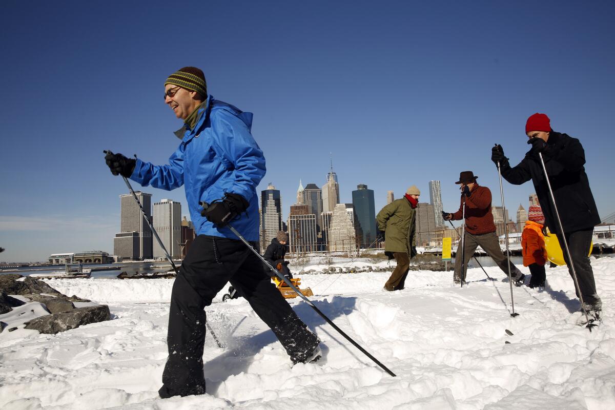 People enjoy cross-country skiing along the waterfront in Brooklyn, N.Y.