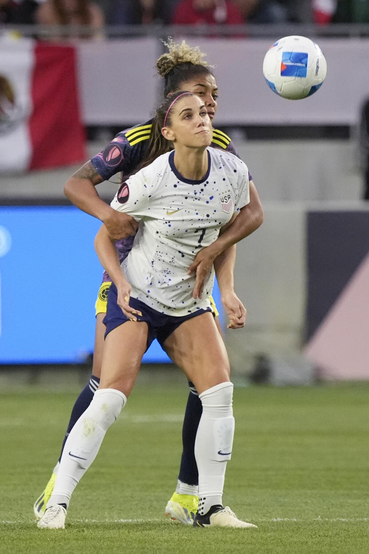 United States forward Alex Morgan (7) is defended by C 