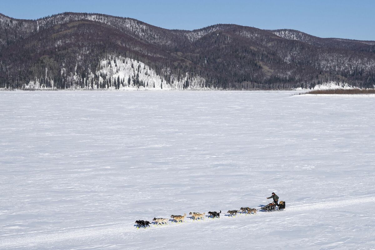 FILE - Brent Sass heads down the Yukon River between Ruby and Galena, Alaska, on March 13, 2020, during the Iditarod Trail Sled Dog Race. The top five mushers in the Iditarod Trail Sled Dog Race appear to be taking an extended break in the ghost town of Cripple, Alaska. Sass was the first musher to reach Cripple Wednesday, March 9, 2022, winning $3,000 in gold nuggets for the feat. (Loren Holmes/Anchorage Daily News via AP, File)