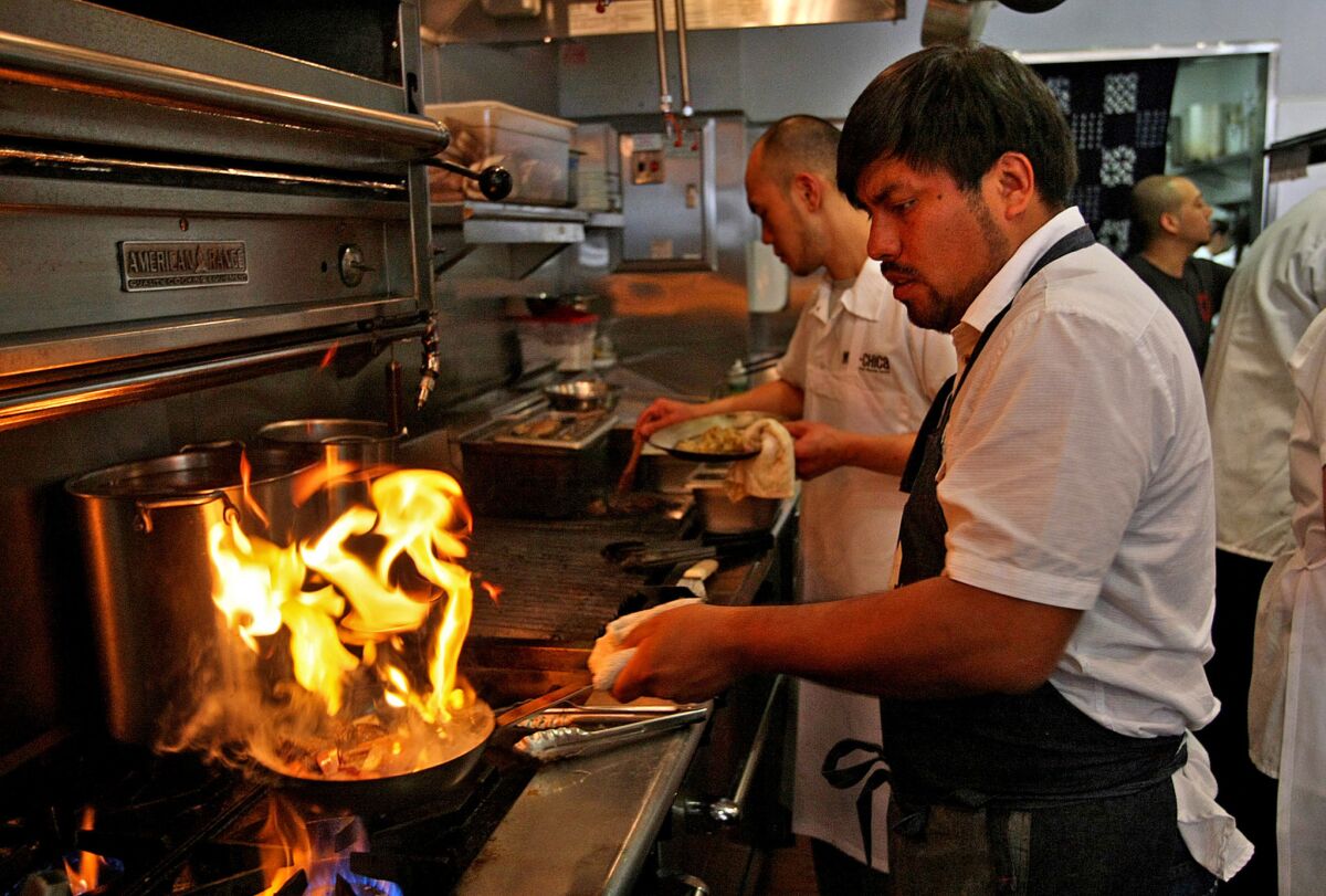 Ricardo Zarate, co-owner and chef of the now-closed Mo–Chica, has signed on to do a pop-up dinner series in Santa Monica. Pictured is Zarate cooking in the kitchen at Mo-Chica.