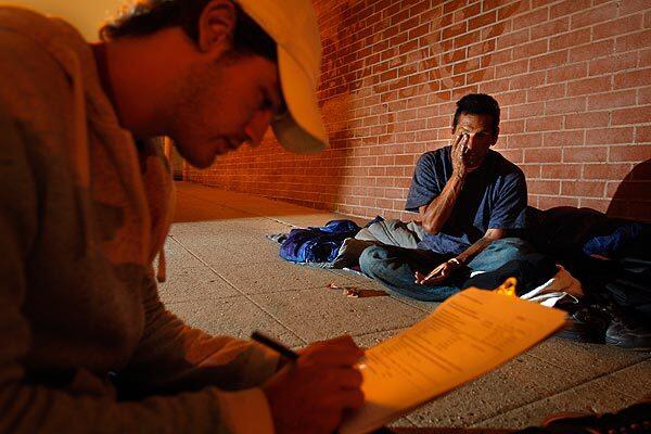 Jake Puffer, 23, of Hollywood interviews Ruben Montoya, 49, about 4 a.m. on the street where Montoya and his girlfriend have been sleeping. Puffer and other volunteers are gathering statistics on homeless people in the area. See full story