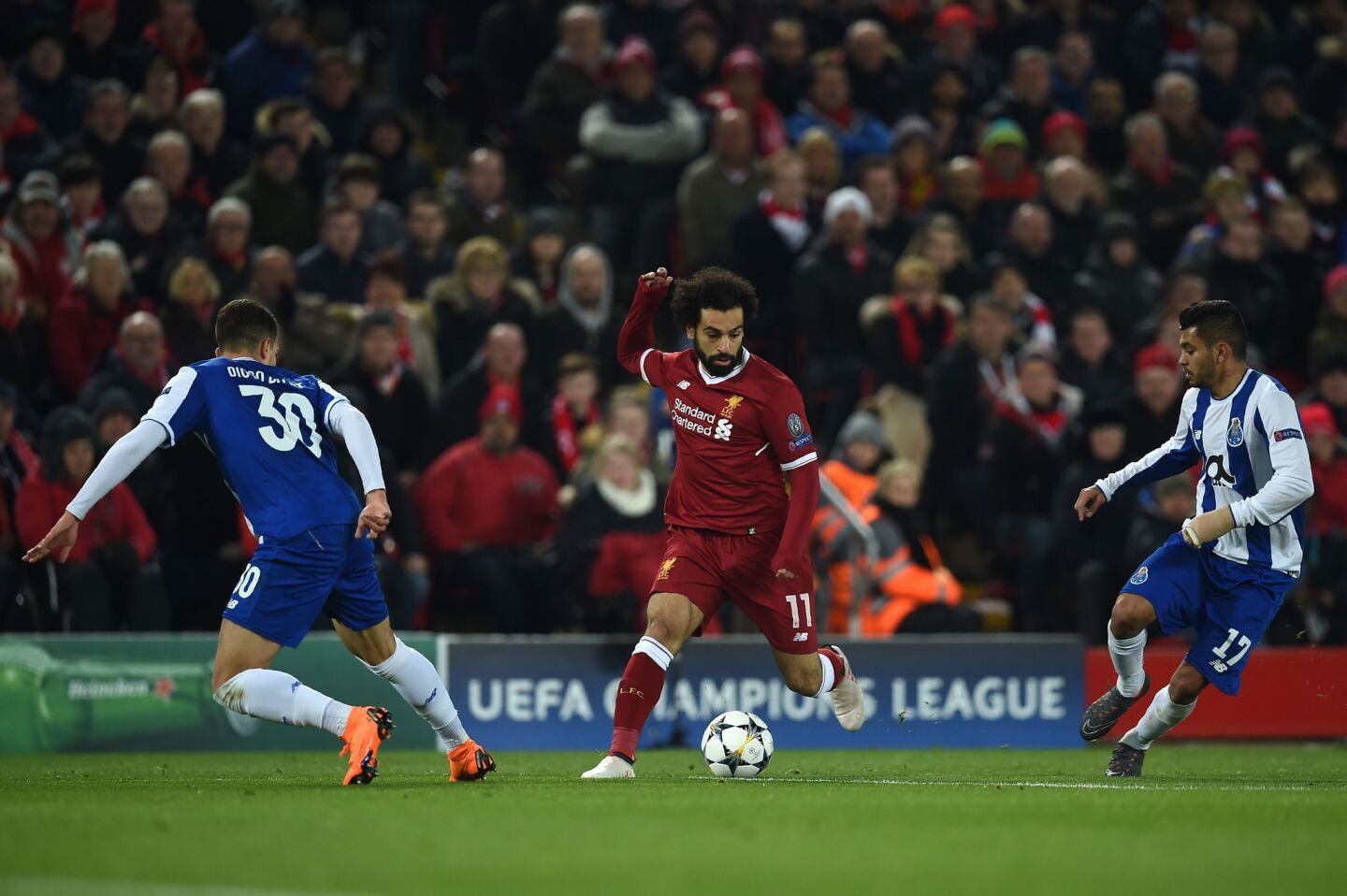 Liverpool's Egyptian midfielder Mohamed Salah (C) is marked by Porto's Portuguese defender Diogo Dalot (L) and Liverpool's Estonian defender Ragnar Klavan during the UEFA Champions League round of sixteen second leg football match between Liverpool and FC Porto at Anfield in Liverpool, north-west England on March 6, 2018. / AFP PHOTO / PAUL ELLISPAUL ELLIS/AFP/Getty Images ** OUTS - ELSENT, FPG, CM - OUTS * NM, PH, VA if sourced by CT, LA or MoD **