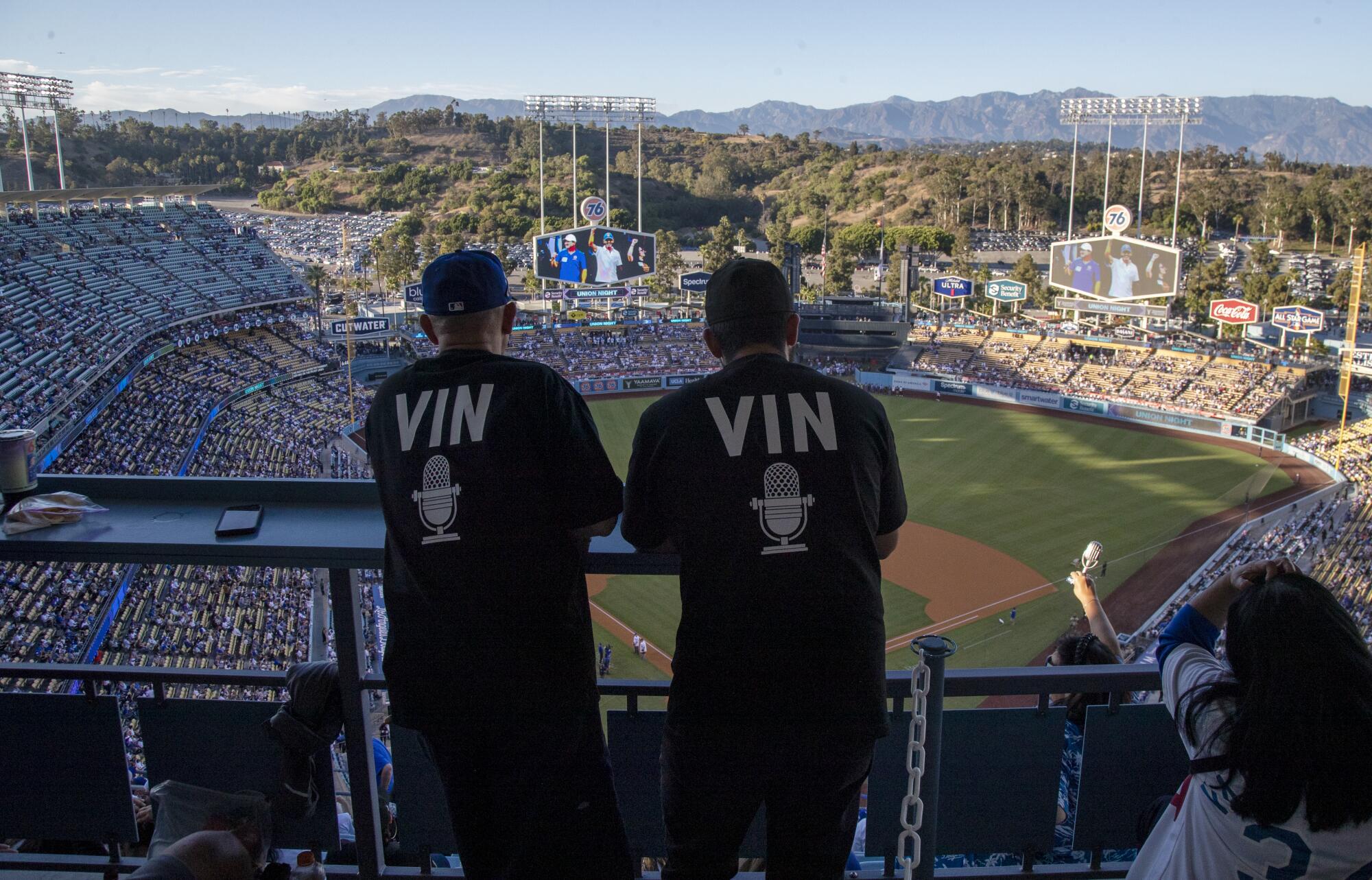 Dodger fans wear VIN T-shirts in honor at Dodger Stadium.
