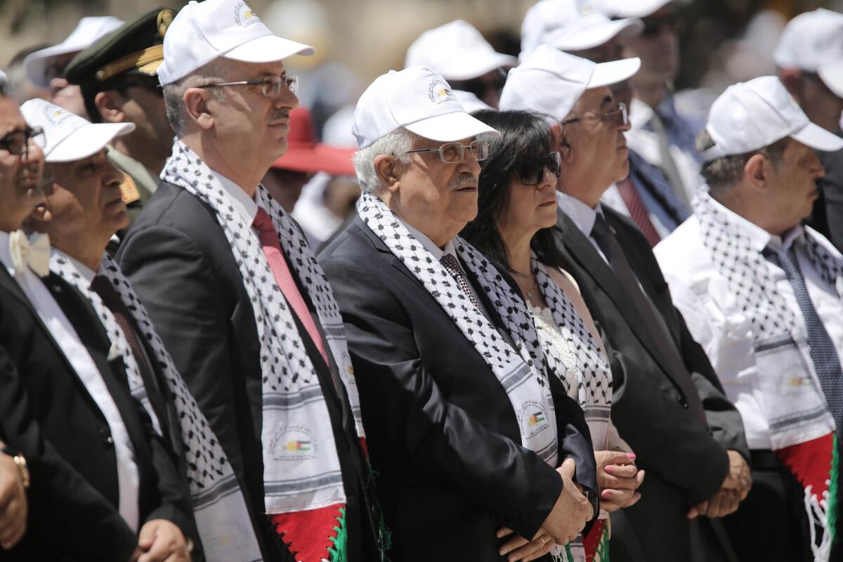 Palestinian President Mahmud Abbas, center, and Prime Minister Rami Hamdallah, third from the left, attend an open-air Mass led by Pope Francis in Manger Square on May 25.