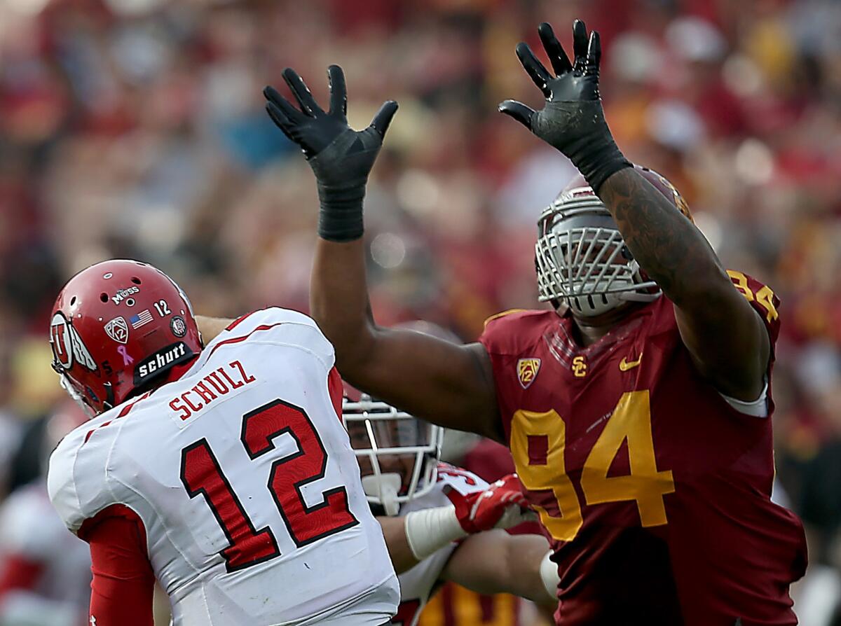USC defensive end Leonard Williams pressures Utah quarterback Adam Schulz during a Pac-12 conference game on October 26, 2013. Williams is one of four Trojans named to the ESPN preseason All-Pac-12 team.