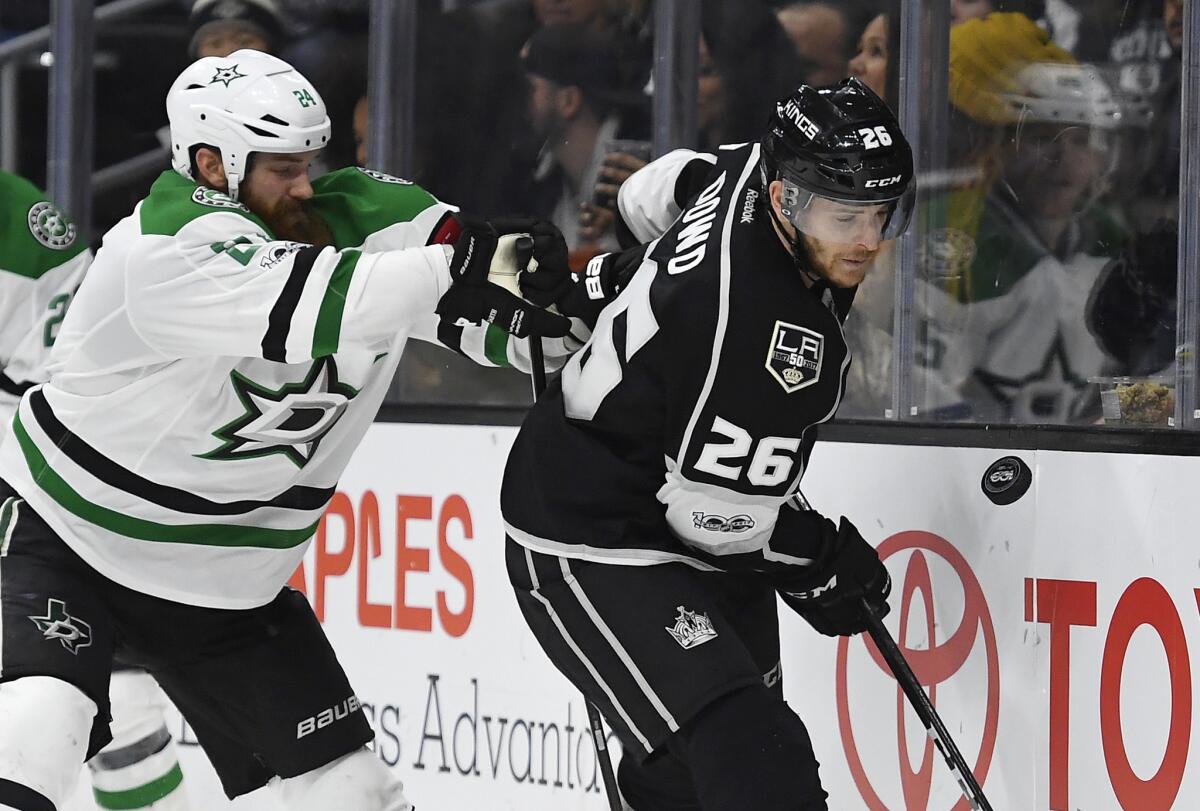 Kings center Nic Dowd, right, battles for the puck with Dallas defenseman Jordie Benn on Jan. 9.