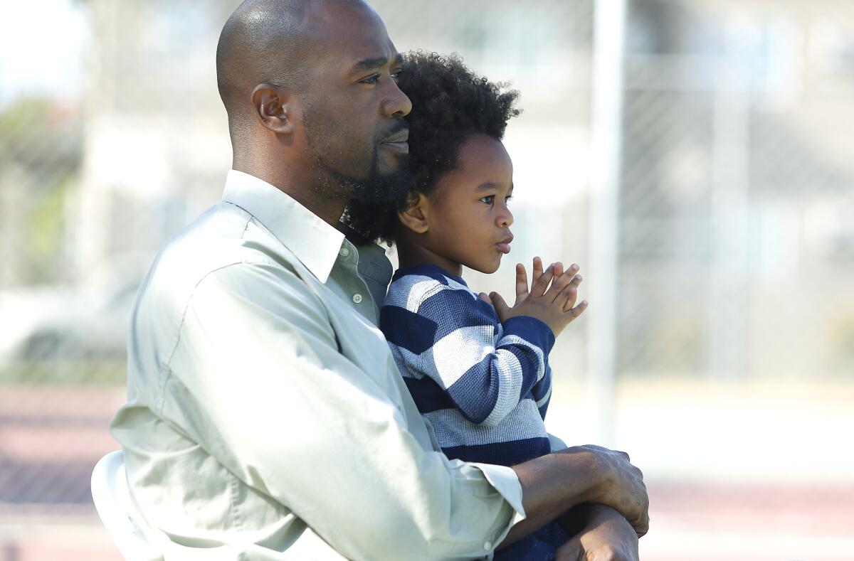 A man holding a little boy