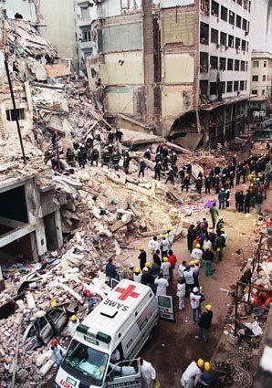 Firefighters and rescue workers search through the rubble of a Buenos Aires Jewish community center destroyed by a car bomb in July 1994. Moughnieh was sought in the attack, which killed 85 people.