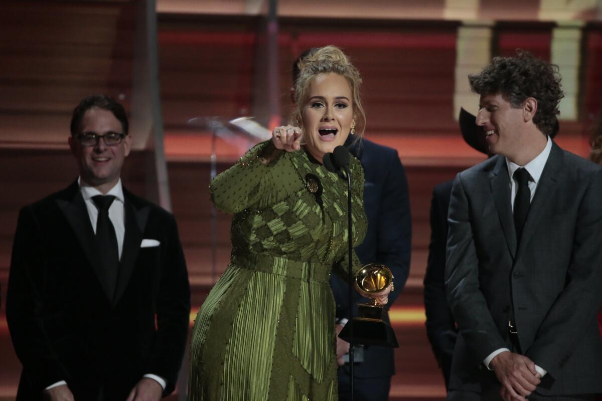 Adele picks up one of her handful of awards at the Grammys on Sunday.