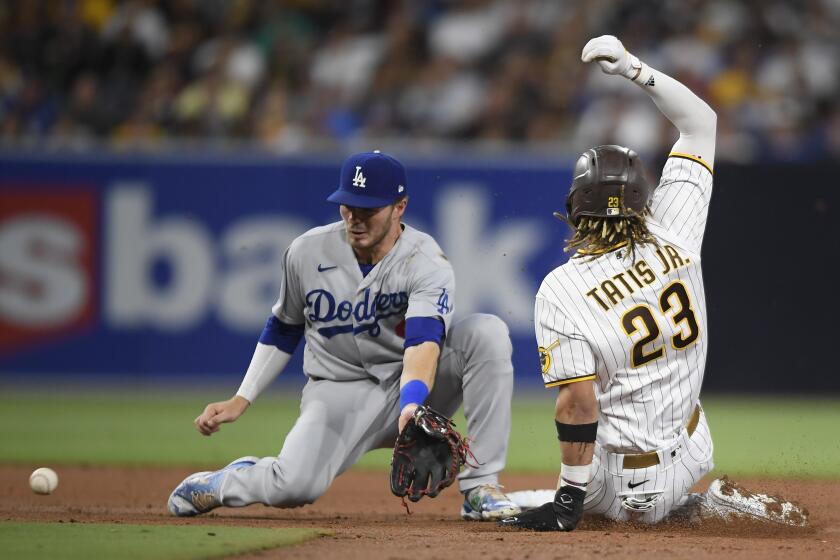 Padres' Fernando Tatis Jr. steals second base ahead of the throw to Dodgers' Gavin Lux on June 23 at Petco Park.