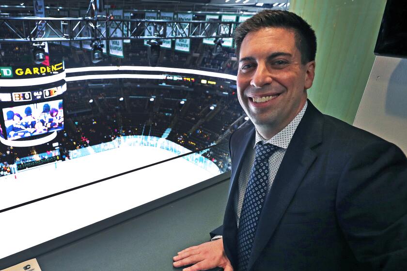 Calgary Flames assistant general manager Chris Snow poses for a portrait in a press box above the ice