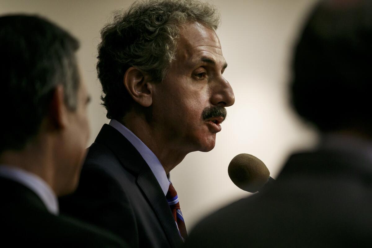 Los Angeles City Atty. Mike Feuer conducted a review into legal settlements involving a law firm that paid a referral fee to one of his staffers. Members of the City Council want a report on Feuer's findings.